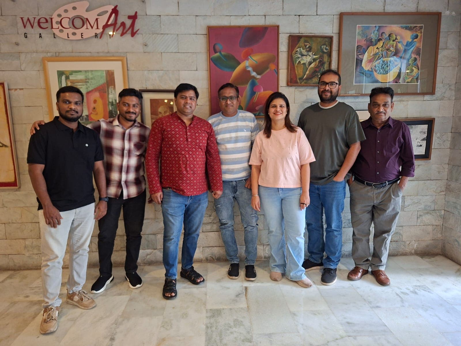 The Travel Unlimited team standing together in an art gallery